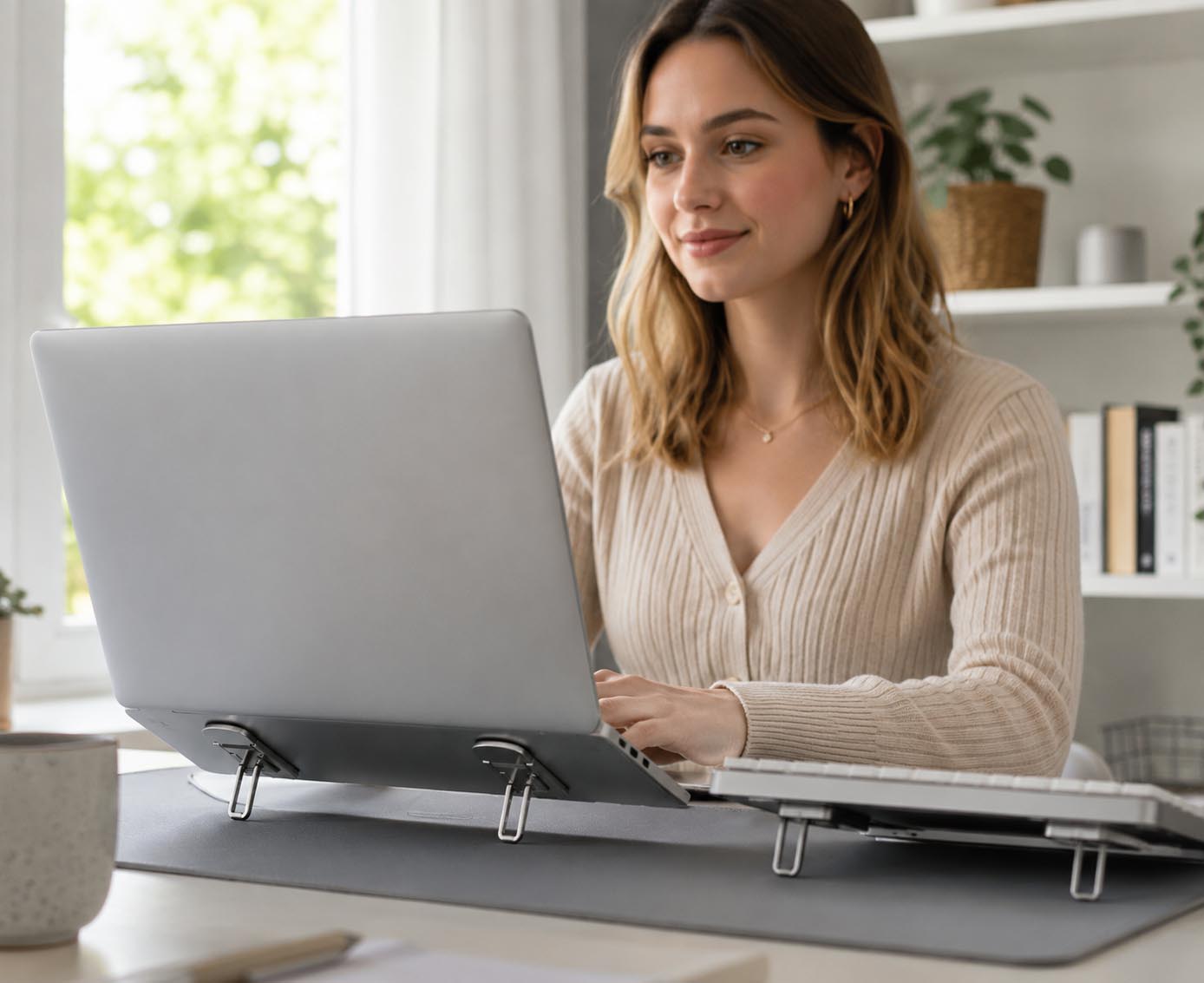 Jessica using the invisible laptop stand at a home office