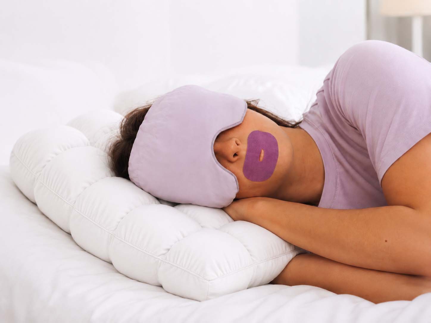 Woman resting on pillow with weighted eye mask